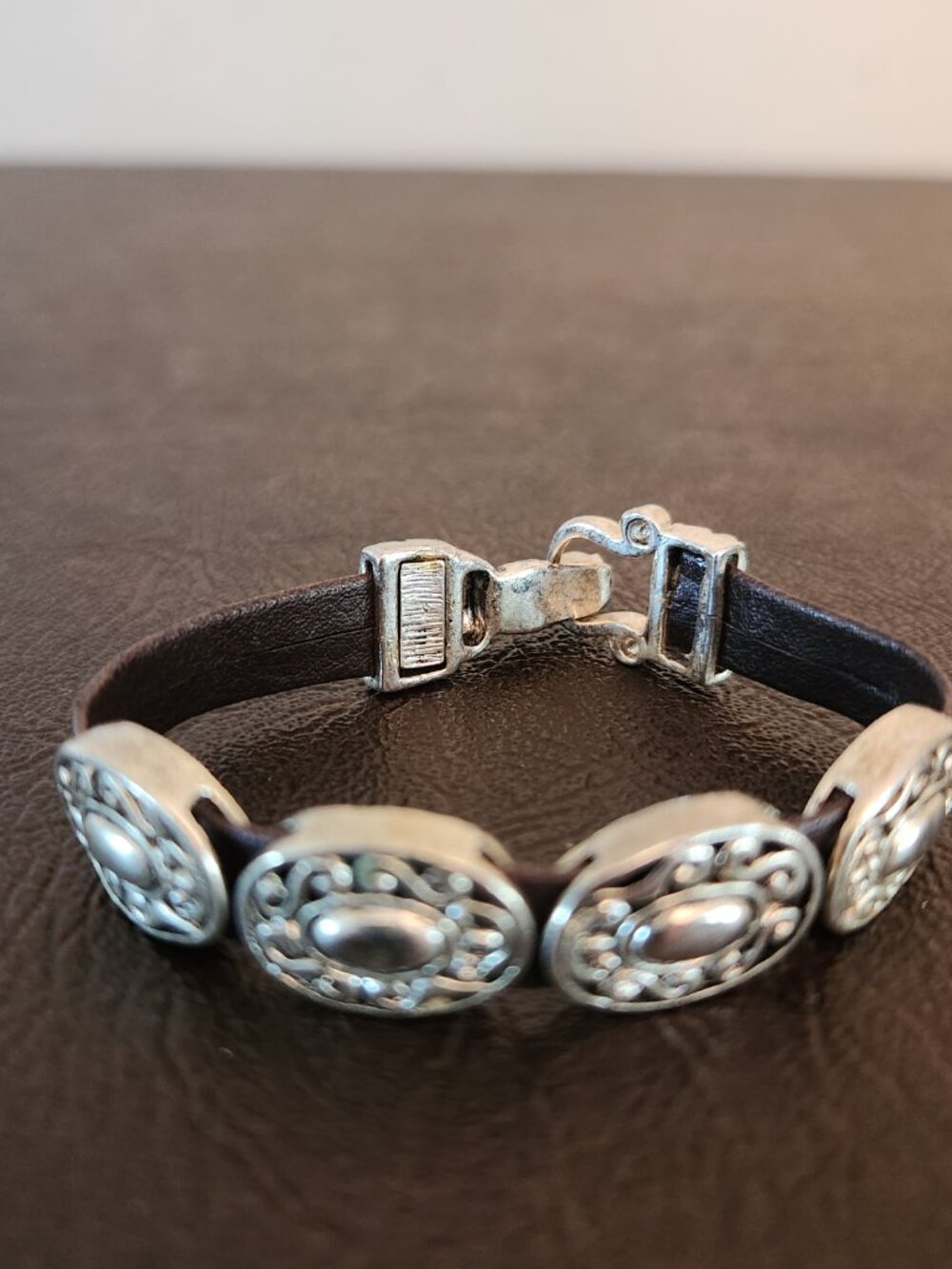 Brighton Harmony Bandit Bracelet silver plated conchos with a buckle closure.